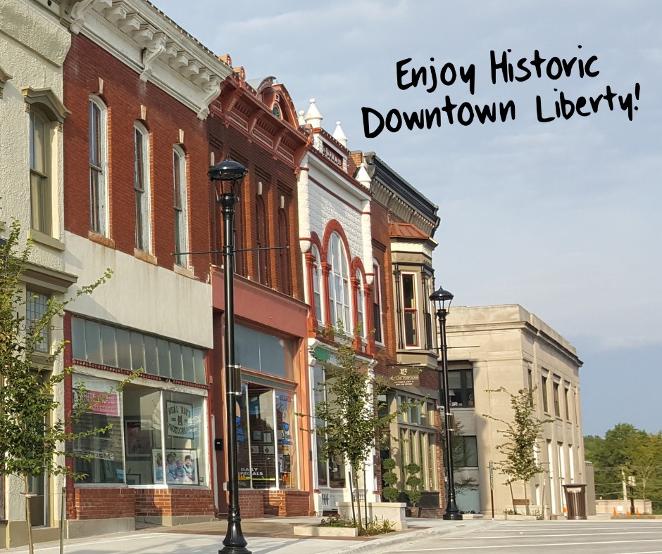 The red brick Victorian storefronts of the Liberty Square in downtown Liberty, Missouri, with cast iron street lamps